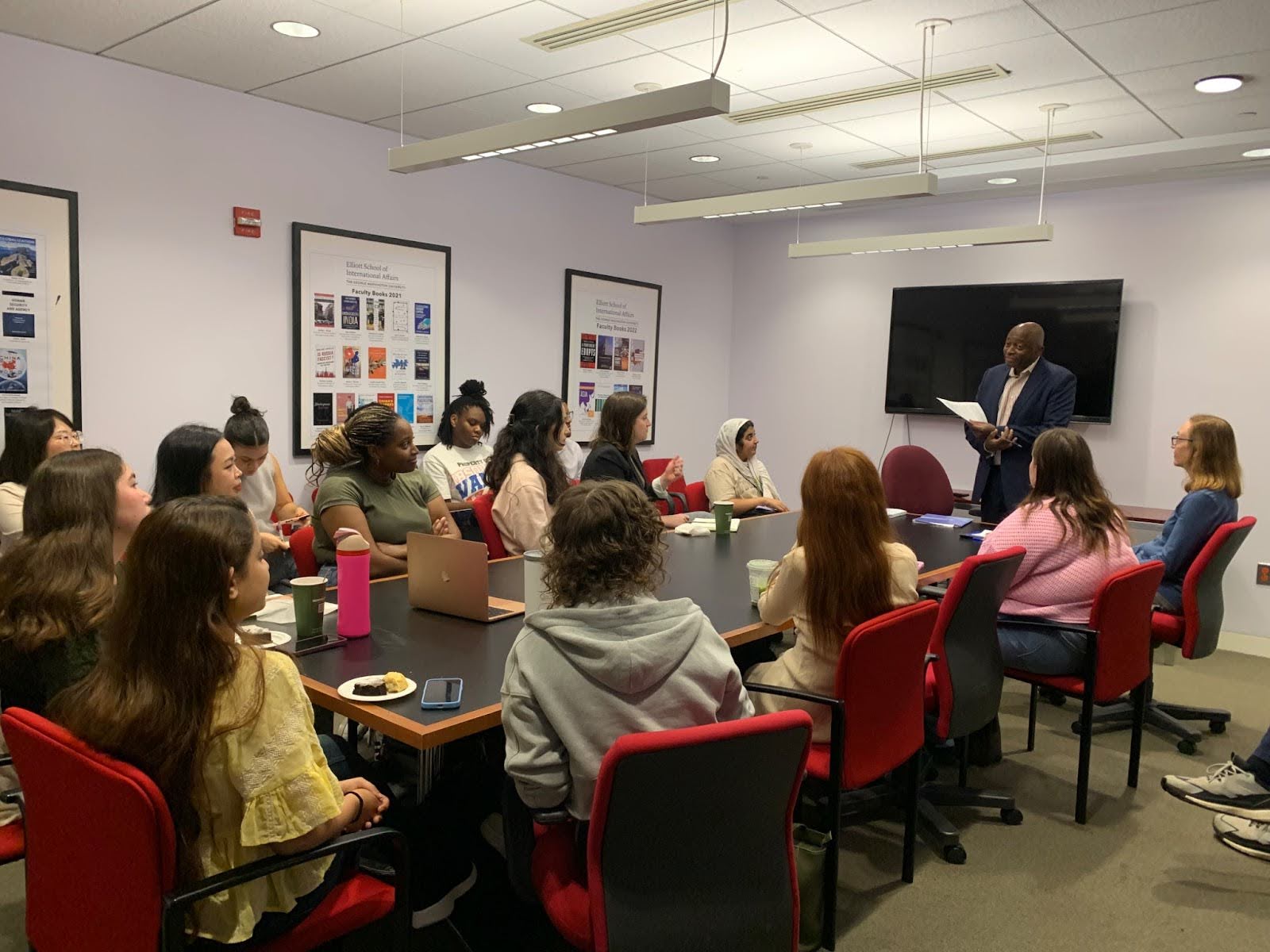 boardroom with people listening to a speaker
