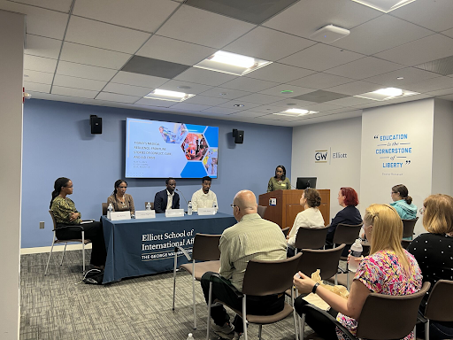 Elliott school panel sitting in front of audience