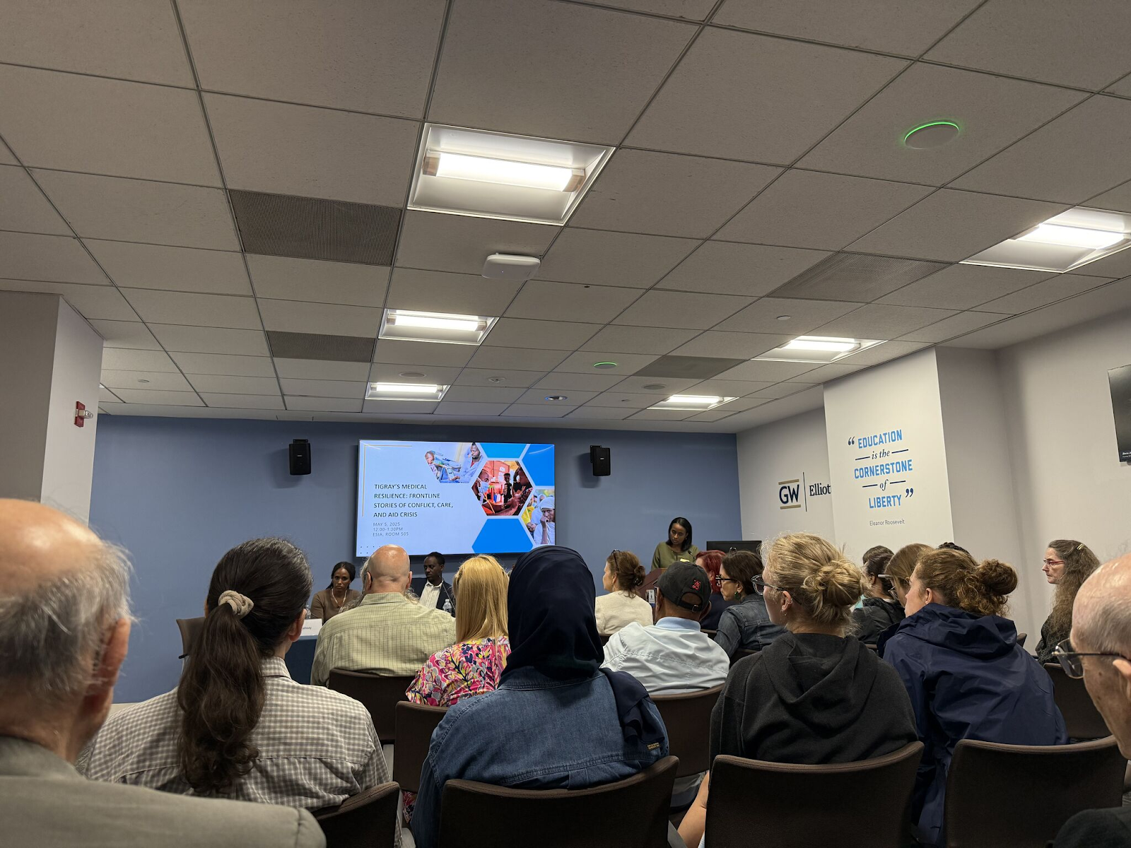 Elliott school panel sitting in front of audience