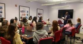 boardroom with people listening to a speaker
