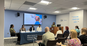 Elliott school panel sitting in front of audience